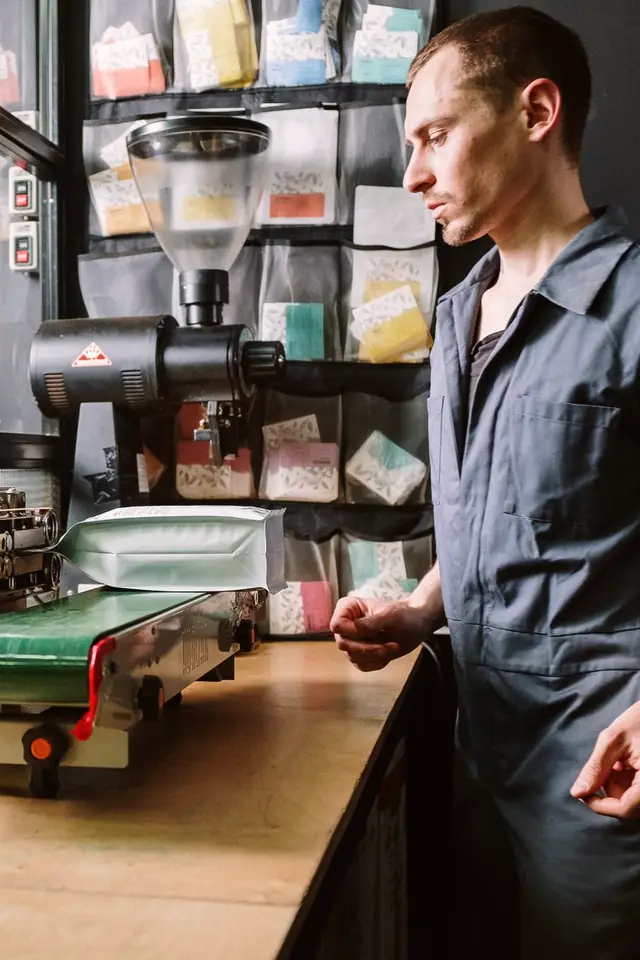 The founder checking the grinder at the bench